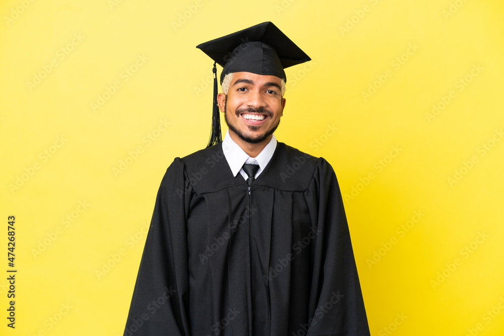 Poster Young university graduate Colombian man isolated on yellow background laughing