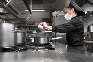 Portrait of confident female chef working in commercial kitchen. High quality photo