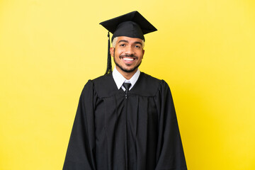Young university graduate Colombian man isolated on yellow background laughing