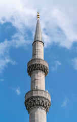 Minaret and blue sky and clouds in the background