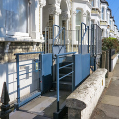 London, England - April 20 2019 - A house in Balham, London, England with an adaptive wheelchair lift outside a house.  This can allow disabled people and wheelchair users access to the house.