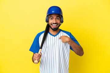 Young Colombian latin man playing baseball isolated on yellow background with surprise facial expression