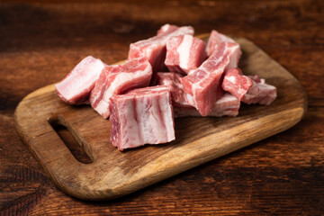 Pieces of fresh raw meat - pork ribs on a cutting board.