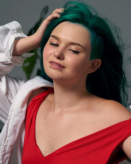 girl with green colored hair in red body and white shirt