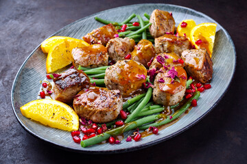 Modern style jusy seared pork pigllet tenderloin fillet meat medallions with orange relish sauce,...
