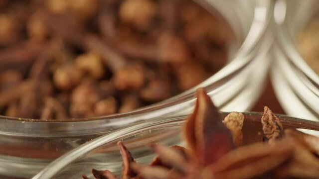 Spices in glass bowls close-up. Middle eastern and arabian culture. Seasoning and flavors. Pepper, coriander, star anise, paprika, cumin. Different kinds of dry herbs for cooking. 