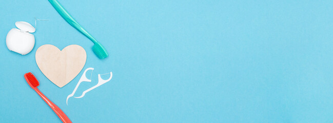 Banner. Teeth hygiene and oral dental care products. Oral care kit. Copy space. Text. Dental toothbrushes. Flat lay. Health care. Blue background. Concept