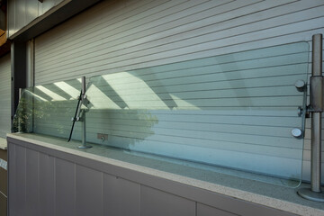 View of a glass sneeze guard protecting customers' food at a closed concession stand at a baseball...