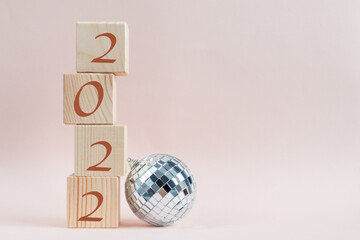 Wooden cubes pyramid with new year numbers and shining disco ball