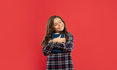 positive pupil or student hold notebook. teen girl study with book. child holding copybooks.