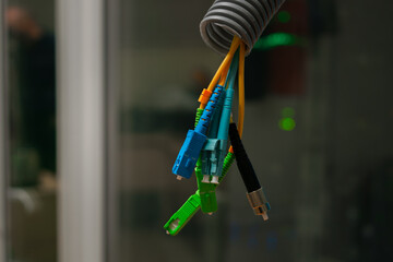 Fiber optic cables are in the corrugated tube. Several optical wires are in the background of the...