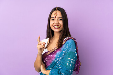 Young Indian woman isolated on purple background laughing