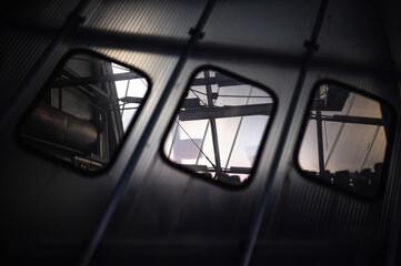 Looking through the windows of a storage building made with minimalist materials.
