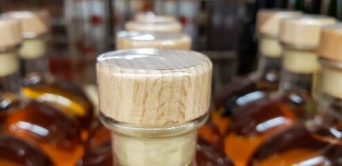 Whiskey bottle closed with a wooden stopper.
