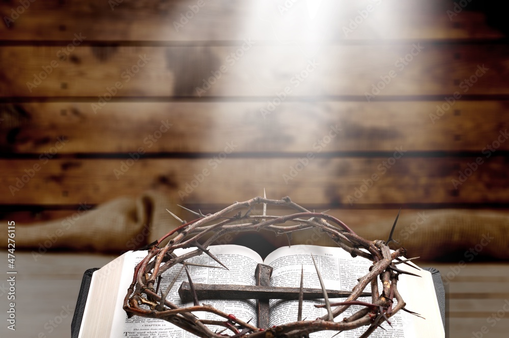 Poster Dramatic bright light beam shining on an old bible with a rosary laying in front of it.