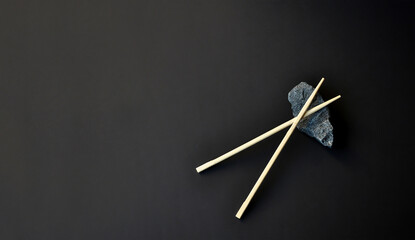 Dark background. Chinese food sticks. East Asian vibes. Minimalism