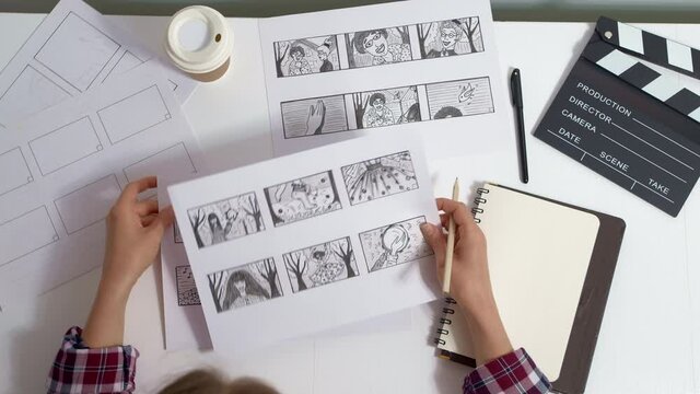 The artist draws a storyboard for the film. The director creates the storytelling by sketching footage of the script on paper.