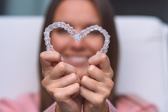 Woman with dental invisible invisalign braces or silicone trainer. Aligners treatment