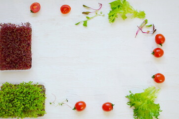 sprouts of sprouted seeds, micro greens, tomatoes, salad on a light background.
food for vegetarians.
background with place for text.