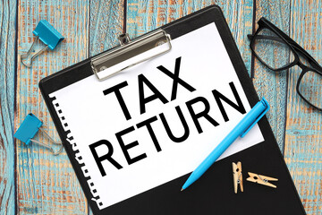 tax return. text on paper in folder on wood background