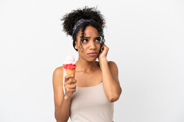 Young african american woman with a cornet ice cream isolated on white background frustrated and covering ears