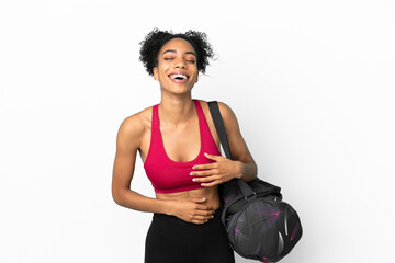 Fototapeta na wymiar Young sport african american woman with sport bag isolated on blue background smiling a lot