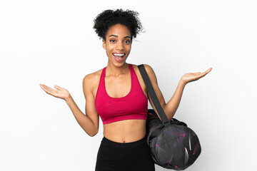 Fototapeta na wymiar Young sport african american woman with sport bag isolated on blue background with shocked facial expression