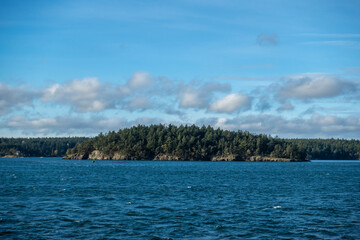 View of a vibrant blue sky above the San Juan Islands from the Anacortes Ferry in Washington.