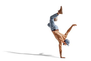 Shirtless man in jeans performing a one hand stand