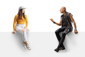 Punk talking to a female teenager while sitting on a blank panel