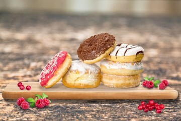 Hanukkah sweet food doughnuts sufganiyot with powdered sugar and fruit jam. Jewish holiday Hanukkah concept.
