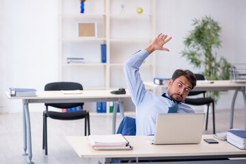 Young male employee working in the office