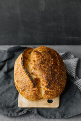 yeast-free sourdough bread. a beautiful European woman baker holds bread in her hands. bake bread for lunch or for sale. a recipe for healthy and delicious bread for the whole family. bakery or