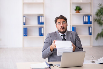 Young male employee working in the office