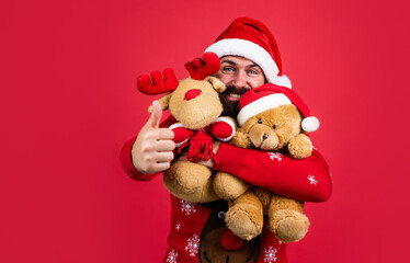 Surprise. bearded man in santa claus costume. hipster celebrate xmas party with reindeer and bear toy. winter holiday preparations. present and gift shopping sale. happy new year. merry christmas