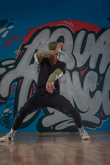 Modern rapper dancing in garage. Urban lifestyle, hip hop.