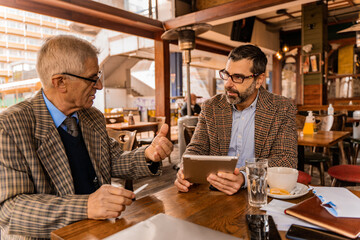 Having a discussion about the documents on the tablet while sitting