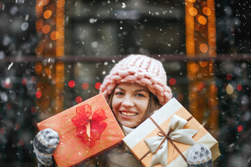 Pretty lady receiving gift against decorated showcase