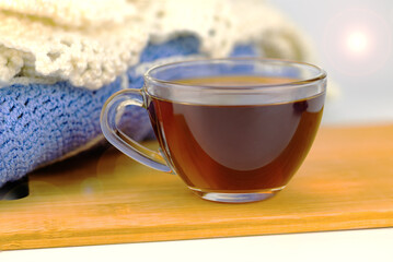Cup of tea, knitted plaid, close up 