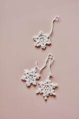 Sustainable and eco-friendly Christmas deco, handmade crochet cotton snowflakes, flatlay on beige