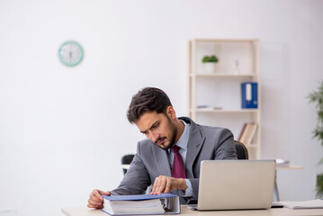 Young male employee working in the office