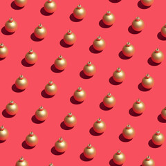 Christmas decor concept with golden baubles on dark pink background. Minimal pattern visual composition, New Year and winter holiday abstract idea.