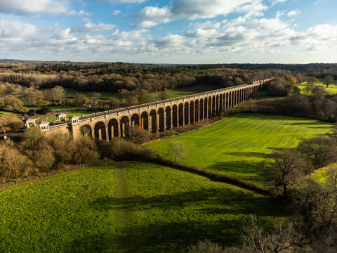 An aerial shot of the Ouse Valley Viaduct and surrounding landscape in the late afternoon sunlight