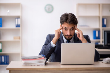 Young male employee working in the office