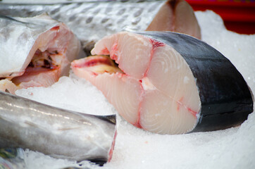 Fresh Mackerel fish cutlet on ice in close-up at fish market.