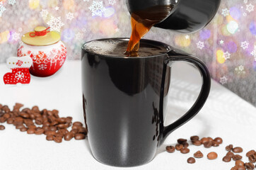 Coffee is poured into a mug on a Christmas background
