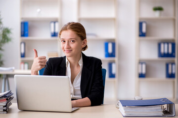 Young female employee working in the office