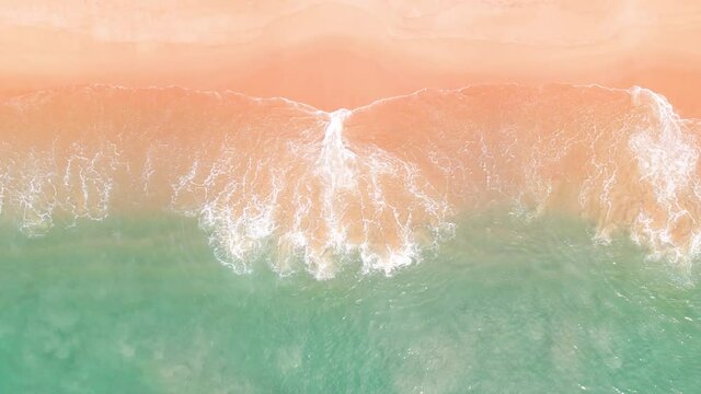wave breaking shoreline. Landscape drone shots sea bright water.