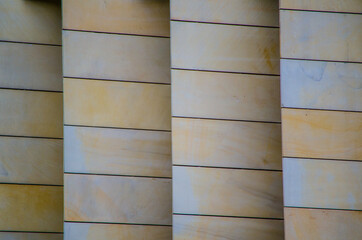 Design sandstone wall pattern built in layers in cream color.