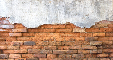 Old brick wall with peeling plaster